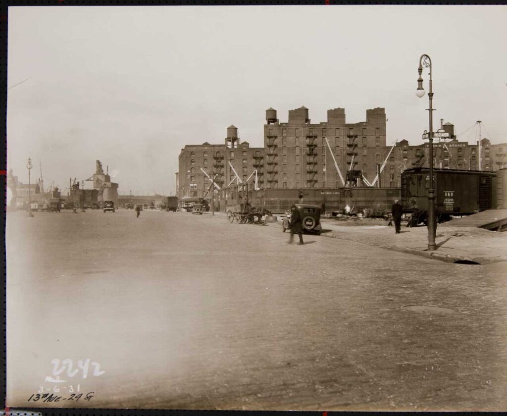 Thirteenth Avenue at 24th Street, March 1931, with coal yard at left and Baltimore & Ohio rail yard at right. Photo: New York City Municipal Archives