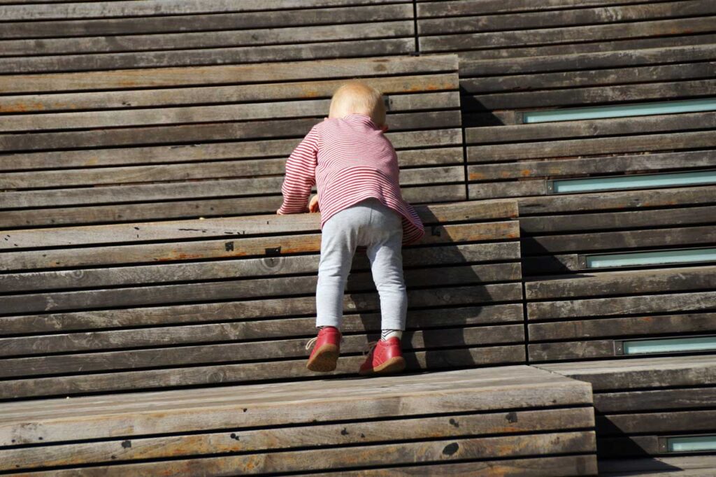 A toddler tackles the Spears bldg. seating steps on the High Line.Photo: Annik LaFarge, author of On the High Line
