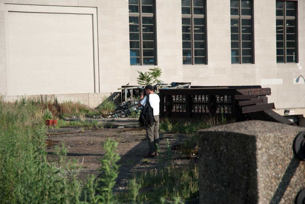 Rick Darke shooting across the abandoned Tenth Avenue Spur toward the opening for mail trains, July 2011. Photo: Annik LaFarge, author of On the High Line