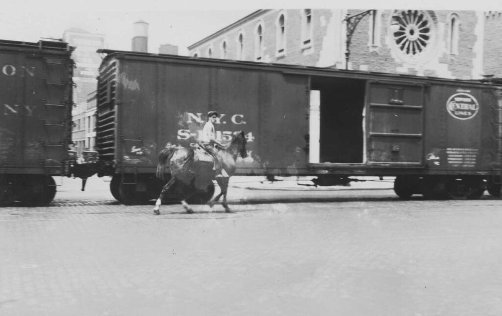 West Side Cowboy riding north on Tenth Avenue past the Guardian Angel Church, 1931. Photo: Percy Loomis Sperr @ Milstein Division, The New York Public Library